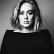 A black-and-white portrait of Adele pouting in a black top