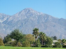 Cucamonga Peak looms over Alta Loma which lies along the foothills of the Southern face of the San Gabriel Mountains Cucamonga Peak West.JPG