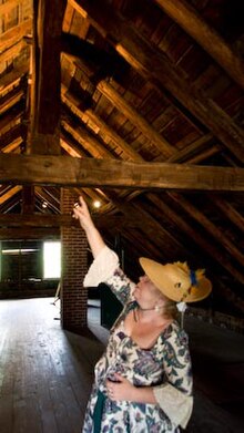 Docent pointing out the Norman truss (king post) roof system Gui Valle Roof.jpg