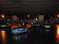 A group of youngsters having fun with the bumper cars.