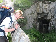 A walker points to the old 'tourist' entrance to the caves D.O.E. Silver Practise - Dorset 046.jpg