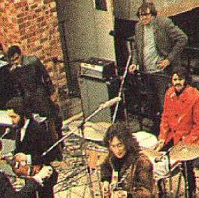 Evans (with hand on hip, behind Ringo Starr) on the Apple Records rooftop during filming for Let It Be