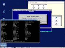 Some of the compatibility subsystems in ArcaOS - a Bash shell (bottom left), QBASIC in a DOS window (middle), and the Windows 3.1 Program Manager (top right) Arcaos-5.0-compatibility.png