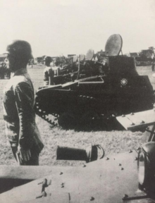 Type 94 tankettes on parade (note the driver's Stahlhelm and the KMT blue and white sun emblem on the tanks) Nanjing Government Army Type 94 tankettes.png