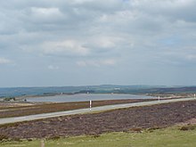 Smiddy Shaw Reservoir, near Waskerley and the Sea to Sea Cycle Route, on barren Waskeley Moor, County Durham looking northeast towards Consett. The Moorcock pub is near the east end of the reservoir. Smiddy Shaw Reservoir, Waskerley.jpg