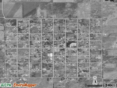 Satellite photograph showing the layout of Manassa's streets. Farmland and ranches abound in all directions, giving way to foothills and high mountain