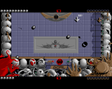 In game shot (Amiga). The black puck has just missed the goal after being deflected by the silver balls. Ballistix-amiga.png