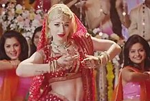 A screenshot from the video, with Azalea in a red sari and bindi inspired by the Bollywood disco era. Iggy Azalea Bounce MV.jpg