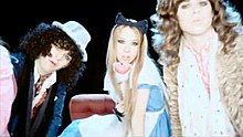 Influences from Alice in Wonderland and 1970's glam rock are shown in the "Wait for me There" video. Wait for me There Video.JPG