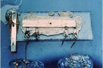 The world's first integrated circuit, created by Jack Kilby. Made from germanium with gold-wire interconnects.