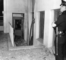 Police officer Peters inspects bomb damage at Roosevelt High on September 29, 1970; Roosevelt was one of CLF's most frequent targets. (Photographed by Russell Pursley for the Herald Examiner, No. 00095526 via TESSA Digital Collections, Los Angeles Public Library) TESSA Digital Collections of the Los Angeles Public Library 00095526 Herald Examiner HE box 41 Bomb rips Roosevelt High School 1970-09-29.jpg