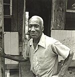 J.B. Murray standing outside his home in [[Sandersville, Georgia]]