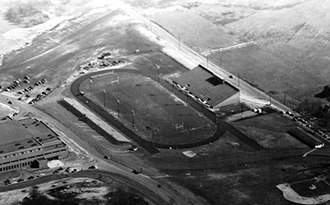 Aerial of Memorial Stadium in 1950 when it was new. The main grandstand is still in use at Dix Stadium. The Memorial Athletic and Convocation Center can be seen on the left Memorial Stadium Kent new.tif