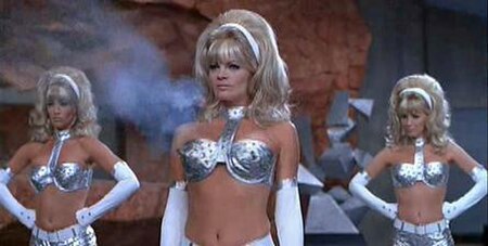 Exaggeratedly feminine fembots with guns in their breasts, from the film Austin Powers: International Man of Mystery