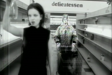 In a surreal moment of the "Push It" video, Shirley Manson leads her partner to his assassination in a Los Angeles deli. GarbagevideoPushitcapture.png