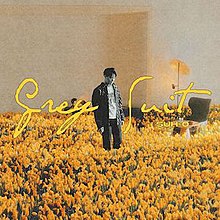 Suho in black and white color in the middle of a yellow flower field