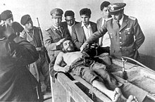 The day after his execution on 10 October 1967, Guevara's corpse was displayed to the news media in the laundry house of the Vallegrande hospital (photo by Freddy Alborta [es])        Face     Side angle    Shoes (Source: Wikimedia)