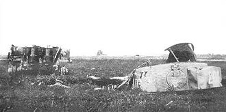 A photograph of a wrecked Tiger 007 tank in a field