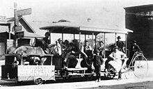 The Monrovia station in 1884 with a streetcar pulled by a mule on Myrtle Avenue in Monrovia, California. The Streetcar was sponsored by Cronenweit Jewelers which has a store in Monrovia and Azusa. The mule would pull the rail streetcar up hill to downtown and then be loaded on trailer and coast down to the station Street car Mule pulled MonroviaCA-1884-Myrtle-Avenue.jpg