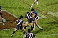 Australia's Joel Clinton "hitting the ball up", i.e. running with it straight at the defence. Hit the line.jpg