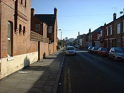 Houses in Woodgate, Leicester. This view is of Central Road looking towards Repton Street. Woodgate Leicester 2007.jpg