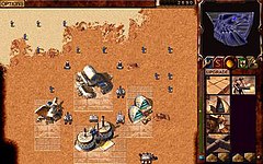 In-game screenshot; the player's base with units is visible. Dune 2000 (Game).jpg