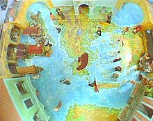 Opening shot of the episode showing the map of the region on the floor of the stylised market set; at the top of the shot is the abbey, top left is the Phoenix, bottom left is the Centaur, bottom right is the Porpentine, top right is a market stall. The entrance to the bay is opposite the abbey, out of shot BBC Comedy of Errors.jpg