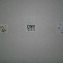 Three small pictures on a white wall.