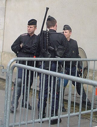 Some gendarmes mobiles equipped with shields, FAMAS and gas mask