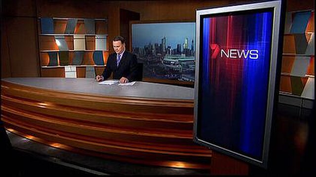 Wideshot of Melbourne's news studio, with Peter Mitchell presenting.