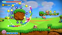 A pre-release gameplay screenshot of Kirby and the Rainbow Curse. Kirby follows a line drawn on the Wii U GamePad and collects stars scattered around levels to activate the "Star Dash" power-up. Kirby and the Rainbow Curse Wii U gameplay screenshot.jpg