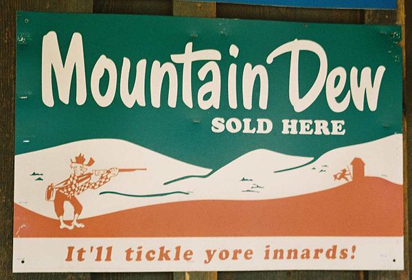 A 1950s Mountain Dew advertisement sign in Tonto, Arizona, showing the cartoon character "Willie the Hillbilly"