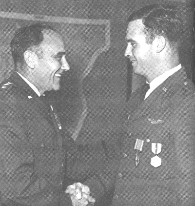 Presenting Distinguished Flying Cross to his son, Captain Michael E. Ryan (right), 1969.