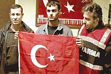 Shortly after Hrant Dink was murdered, the assassin was honored as a hero while in police custody, posing with a Turkish flag with policemen. Ogunsamastflag.jpg