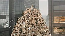 Still from the music video showing Minogue standing atop a pyramid of underwear-clad couples, which was inspired by the installations of American photographer Spencer Tunick Kylie Minogue All the Lovers Music Video.jpg