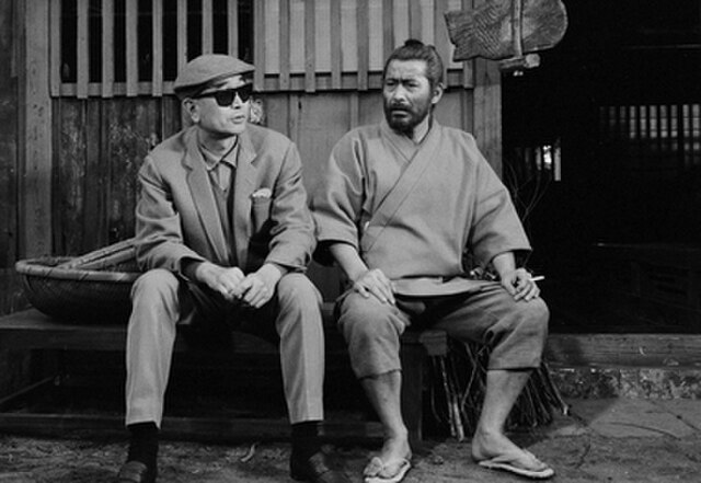 Kurosawa and Mifune taking a break on set during filming. This film would be the last collaboration between the two because of Kurosawa's increasingly