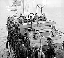 Soldiers crowded on the deck of a Motor Torpedo Boat