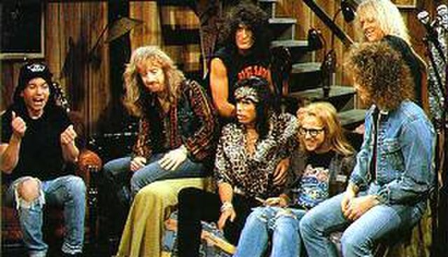 Aerosmith appear in a "Wayne's World" sketch on Saturday Night Live in 1990.