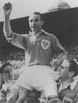 Matthews with Blackpool, lifting his 1953 FA Cup final winner's medal.