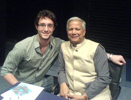 Yunus (right) at a book signing at the London School of Economics