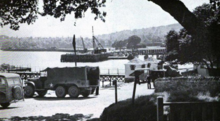 Dock area at the Seabee base. Tanks and industrial section in centre foreground Rosneath Naval base - Deck area at the Seabee base.png