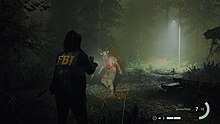 A screenshot of Alan Wake 2, showing the player's character, Saga Anderson aiming her flashlight and handgun at an enemy, in an exterior environment.