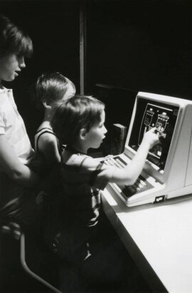 Children using a touch-screen computer at the U.S. Pavilion.