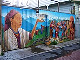 A Precita Eyes' mural on a garage door and fence in Balmy Alley]]