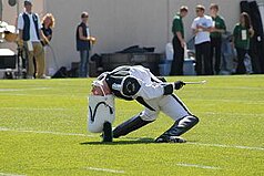 Drum Major Ian McNabb performing the traditional drum major backbend during pregame Drummajorbackbend.JPG