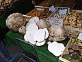 Puffball mushrooms on sale at a market in England, showing slices uniform and white all the way through.