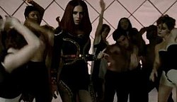 A frame from the "Egyptian-themed" scene in the middle and end of the video, where Cole wears a brunette wig and dances with backing dancers Cheryl Cole 3 Words Video Snap.jpg