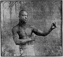 Image of shirtless Harris Martin with his bare fists raised.