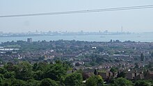 View of Portchester from Portsdown Hill; castle keep on left, Portsmouth harbour and city in background