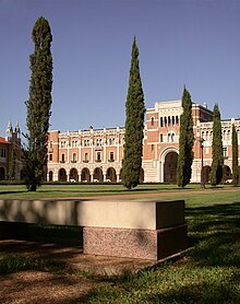 A stone bench in the academic quad, with Lovett Hall visible in the background Founders bench.jpg